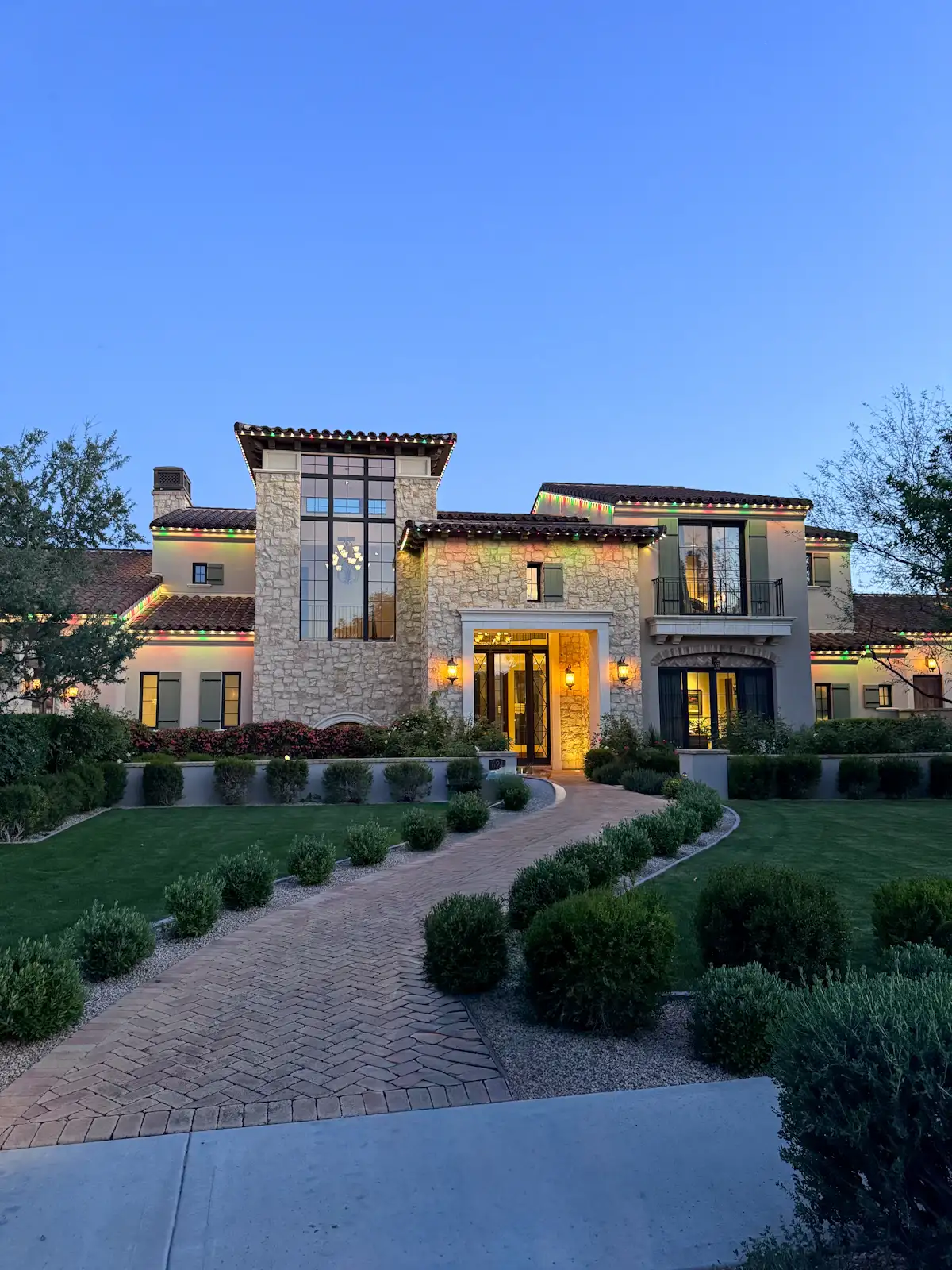 A contemporary stone home at dusk