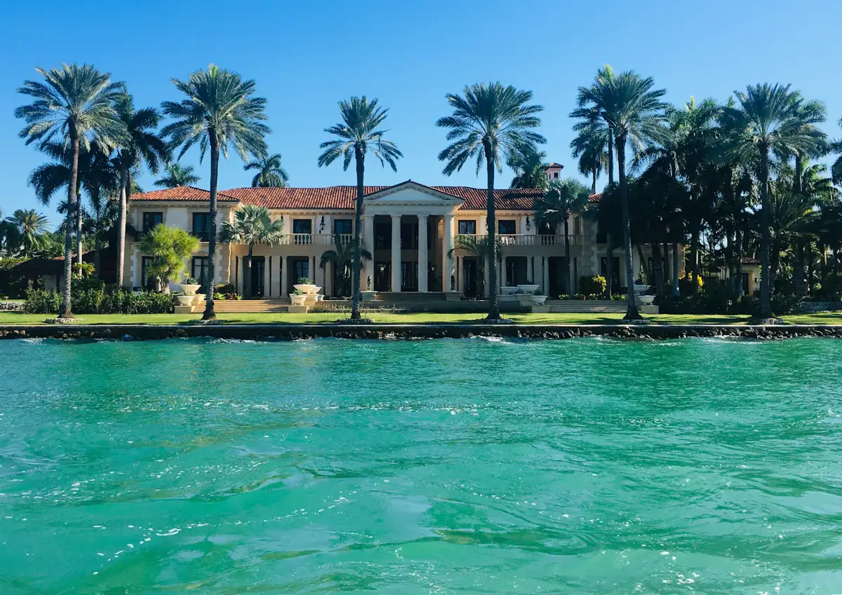 A waterfront estate framed by palm trees