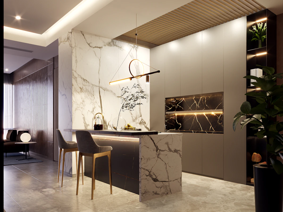 A marble kitchen island under pendant lighting